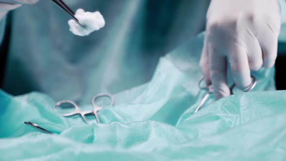 Doctor Performs a Closeup Operation. The Doctor Holds Tweezers with Tweezers and Processes the alt