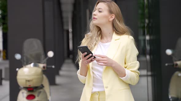 Young Woman Using Smartphone on Street