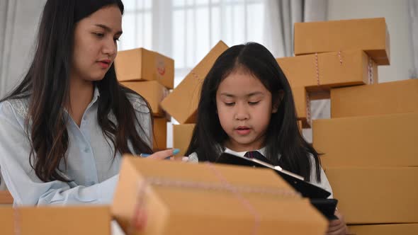 working from home, Asian young women packing product in the box for sell, online business marketing alt