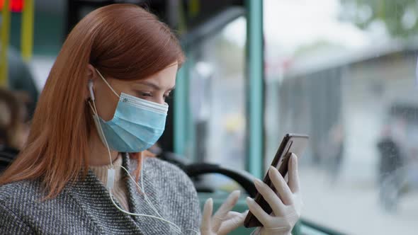 Woman Wearing Headphones Wearing Medical Mask and Gloves Uses Mobile Phone To Protect Against alt