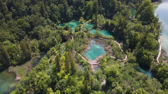 Top view of the Plitvice Lakes National Park with many green plants and beautiful lakes and waterfal alt