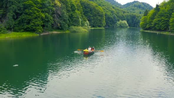 Young Couple in a Boat on the Biogradsko Lake in Montenegro alt