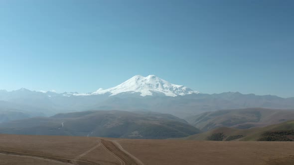 Amazing Aerial Landscape Snowy Peaks Elbrus Mountain. Majestic Snow Mountain Top From Height Flying alt