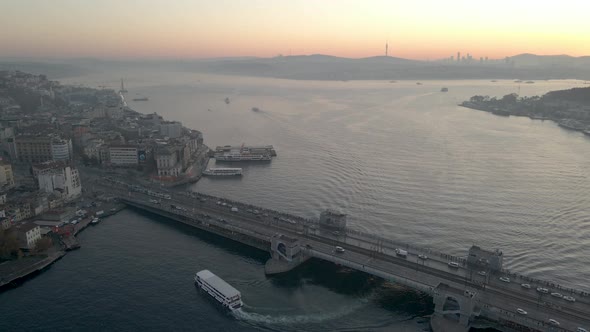 Aerial shot of Galata Bridge. Boat crossing under Galata Bridge.