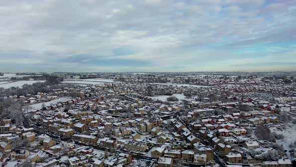 Aerial footage in the winter time on a snowy day of the British town of Mirfield in Kirklees alt