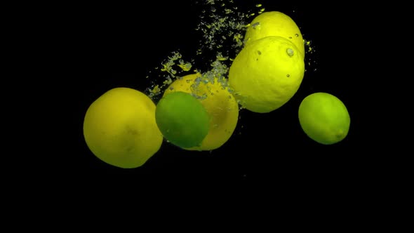 Citrus Fruit in Splash Water on a Black Background alt