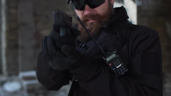 Slowmotion Dolly Shot of Bodyguard Security Guard Draw Gun and Coming Closer to Intruder alt
