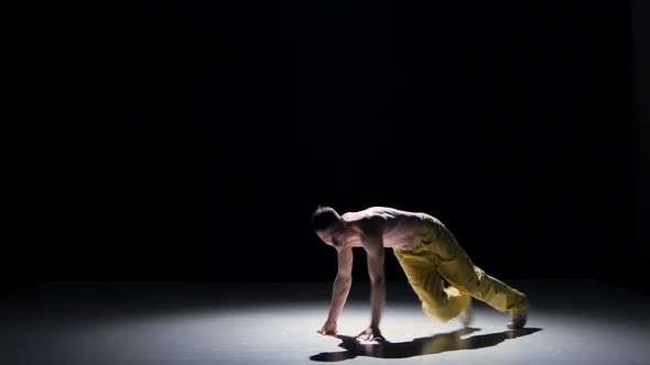 Breakdance Dancer Man In Yellow Suit With Naked Torso Dance On Black Shadow Stock Footage