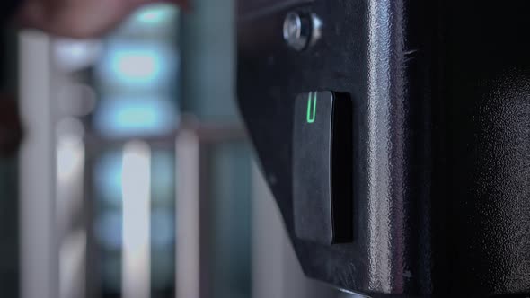 Closeup Female Caucasian Hand Using Card Passing Security Entrance in Business Office in the Morning alt