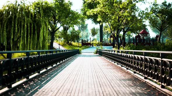 Old Metal Bridge Over a Small River in Park alt