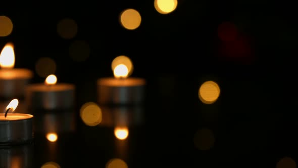 Small candles burning brightly alt