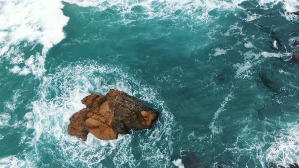 Azure Ocean Waves Roll on Empty Sea Coast with Cliff Rocks alt