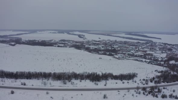 Russian Village in Winter Under a Bright Cloudy Sky