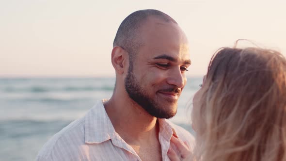 Young Couple in Love Looking at Each Other at the Beach