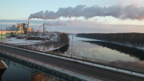 smoke from factory chimneys, flying over river and bridge, woodworking industry