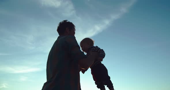 The Father Throws His Son Into the Air alt