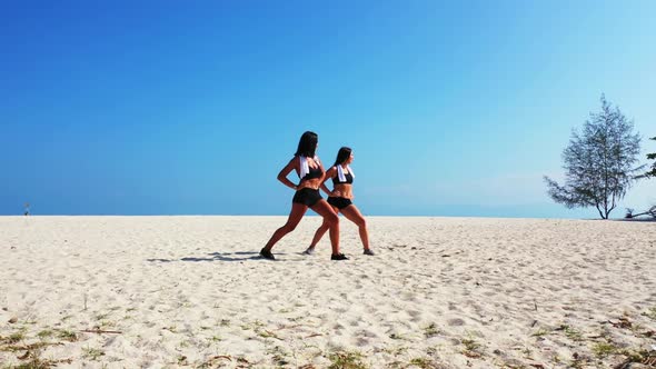Ladies together look beautiful on luxury island beach adventure by blue ocean and white sand backgro alt
