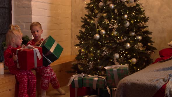 Cute Children with Christmas Presents at Home