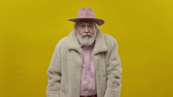 Stylish Old Man In Pink Clothes On Yellow Background alt