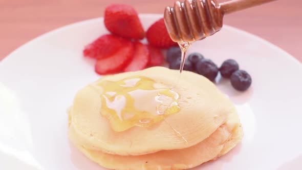 Pouring Honey On Pancake
