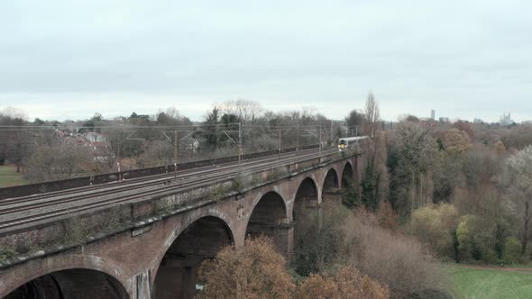 Stationary drone shot of heathrow express train over Wharncliffe viaduct west London alt