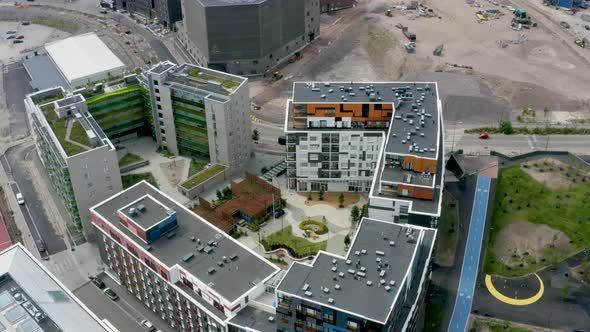 Slow aerial view above a large building with a courtyard in Helsinki, Finland. alt