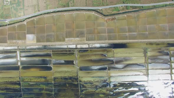 View from above of paved road passing the salt ponds on Pag island, Croatia alt