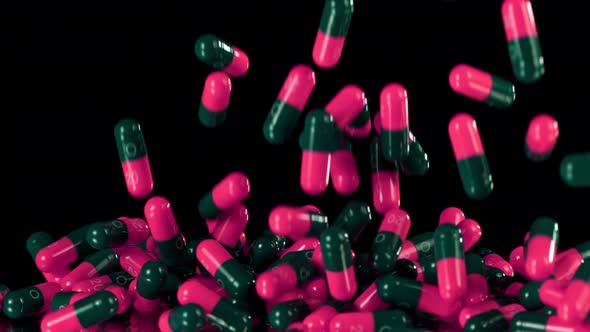 Super Slow Motion Shot of Falling Pink Pills on Black Background at 1000Fps alt