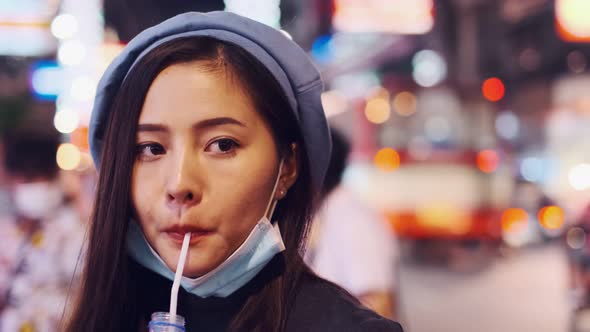 Asian Young woman  Eating Traditional Asian Street Food  at   Market Bangkok alt