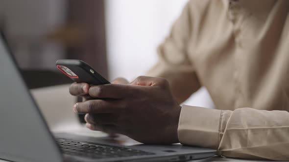 Black Male Student is Using Smartphone Playing Games During Online Lecture Closeup of Male Hands alt