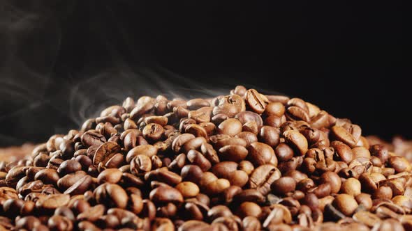 Arabica Quality Roasted Coffee Beans Spin on a Rotating Plate with Smoke alt