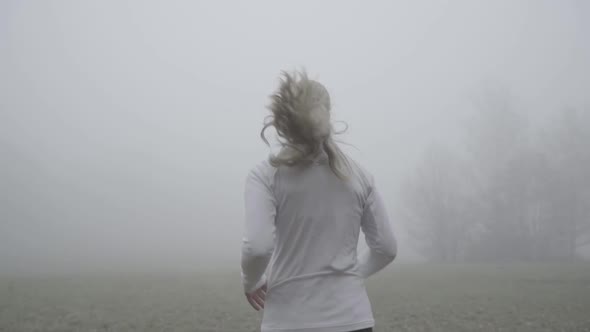 Slow Motion Rear View Upper Body Woman Jogging in Fog