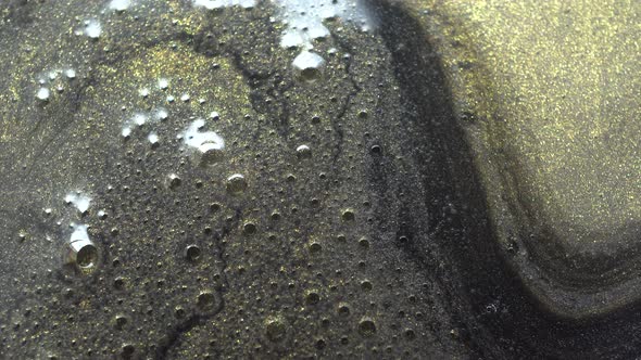 Bubbles From Gold Paint In The Water