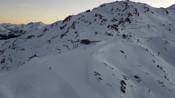 Snowy Mountain Skilifts and Furniculars and Skislopes in Austrian Alps Drone Flyover the Mountains