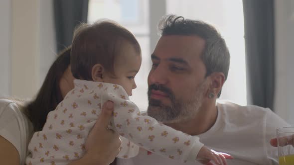Relaxed Young Couple Lying in Bed on Sunday Morning