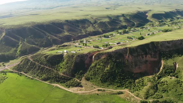 Mountains and grassland in a cloudy day alt