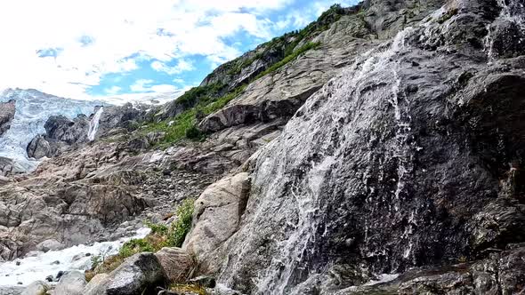 Beautiful Mountain Landscape with a Stream at the Buarbreen Glacier Norway