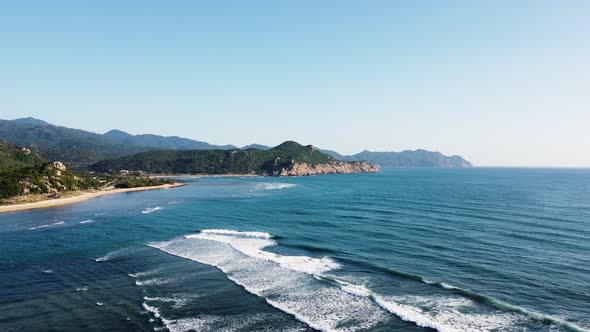 Calm waves on paradise tropical coast in Hang Rai, Vietnam, aerial view alt