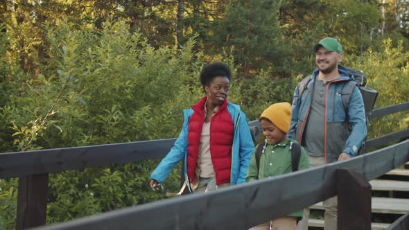 Multiethnic Tourist Family Walking in National Park alt