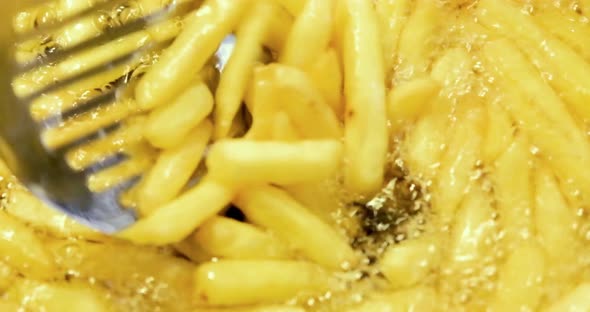 French Fries Are Fried In Boiling Oil. Junk Food Concept.