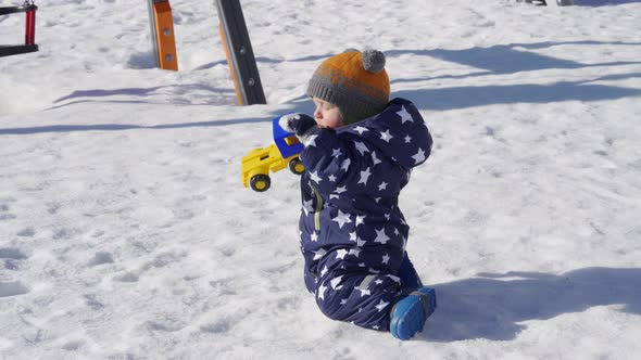 Baby Playing in the Snow in Winter 1 Year Old Baby Boy on a Walk in the Park alt