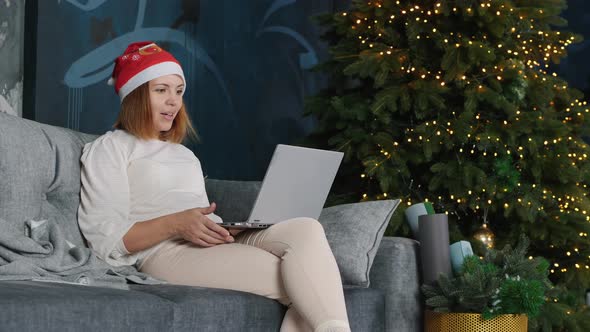 Young Woman Having a Video Call Online on Christmas Eve alt