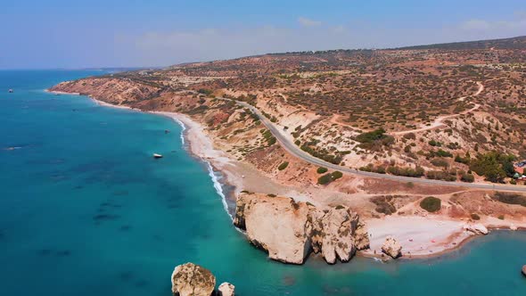 Aerial view flying towards and over Aphrodite's Rock in Paphos Cyprus alt