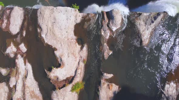 Amazing aerial view of waterfall with rainbow. alt