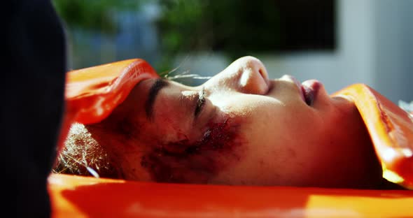 Paramedics examining injured girl alt