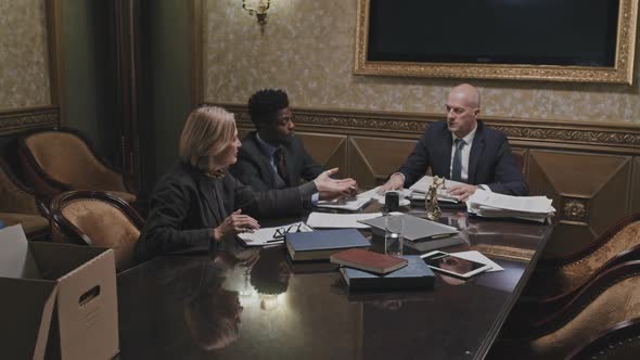 Multiethnic Team Working with Papers in Law Firm alt