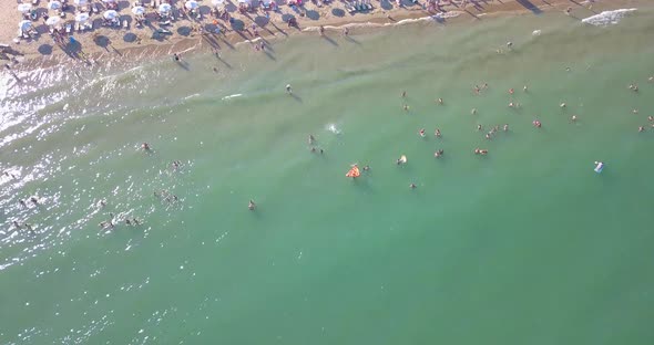 Aerial View of Summer Beach with People in Water