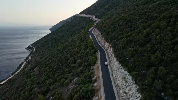 Car Travel Concept Aerial View of Mountain Road Near Sea at Lefkada Island alt