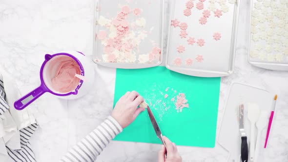 Flat lay. Step by step. Pouring melted chocolate into a plastic chocolate mold in the shape of snowf alt