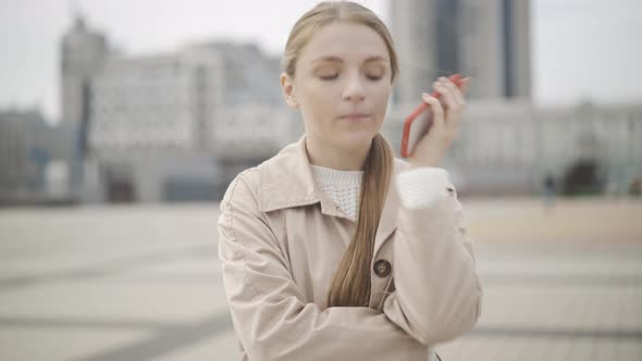 Sad Young Caucasian Woman Arguing with Someone on the Phone. Portrait of Stressed Pretty Lady alt